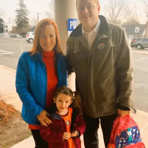 Genevieve Mecher is with her mother and father.